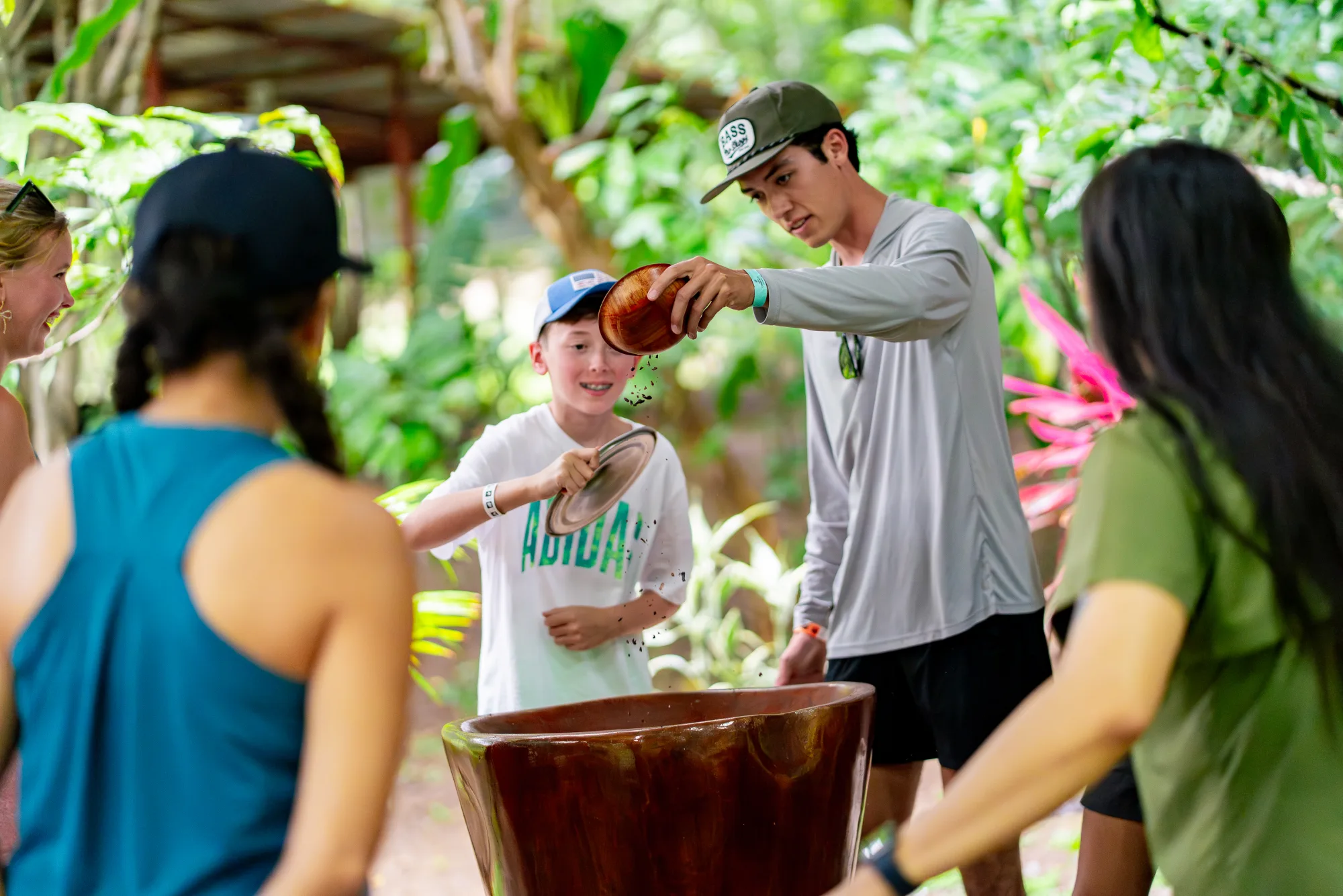 Kids and guides grinding cacao at Vista Los Sueños